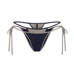 SIGNATURE SWIM LAYERED TIE SIDE BIKINI BOTTOM | NAVY CONTRAST LAYS FLAT ON A WHITE BACKGROUND | FLT