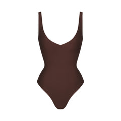 SKIMS BODY UNLINED PLUNGE THONG BODYSUIT | COCOA (SHAPEWEAR BODYSUITS, SHAPEWEAR) LAYS FLAT ON A WHITE BACKGROUND | FLT