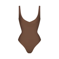SKIMS BODY UNLINED PLUNGE THONG BODYSUIT | JASPER (SHAPEWEAR BODYSUITS, SHAPEWEAR) LAYS FLAT ON A WHITE BACKGROUND | FLT