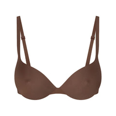 SKIMS ULTIMATE BRA NIPPLE PUSH-UP BRA | JASPER LAYS FLAT ON A WHITE BACKGROUND | FLT