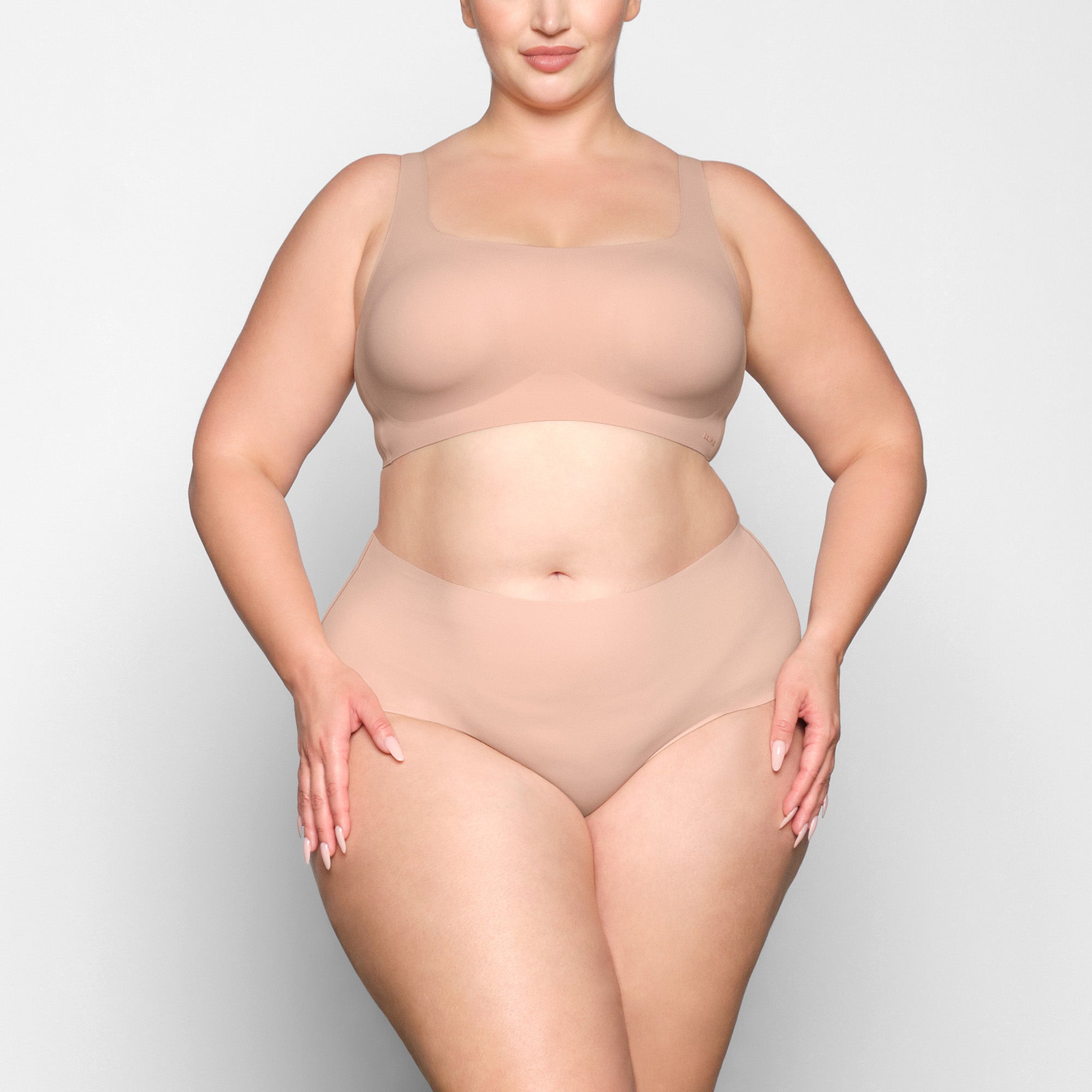NAKED SCOOP BRA WORN BY A MODEL IN FRONT VIEW 