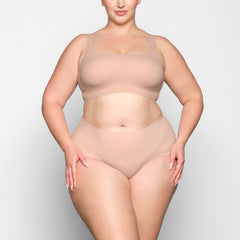 NAKED SCOOP BRA WORN BY A MODEL IN FRONT VIEW 