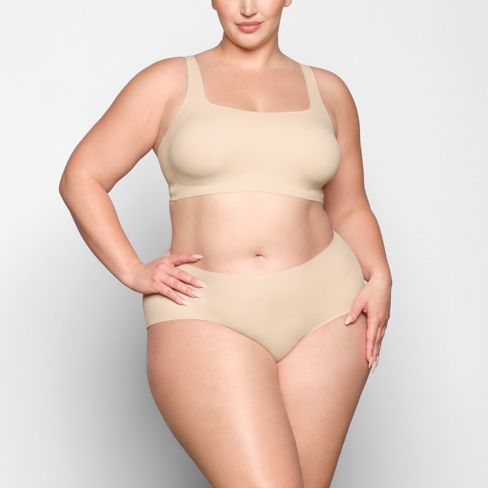 NAKED SCOOP BRA WORN BY A MODEL IN FRONT VIEW 