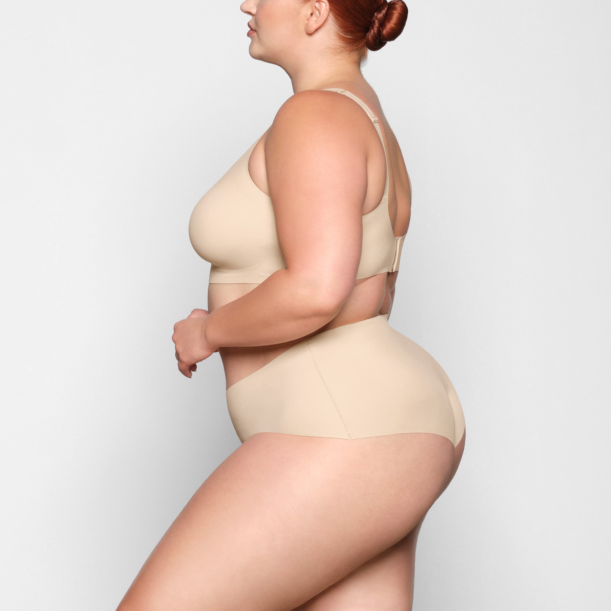 NAKED SCOOP BRA WORN BY A MODEL IN SIDE VIEW