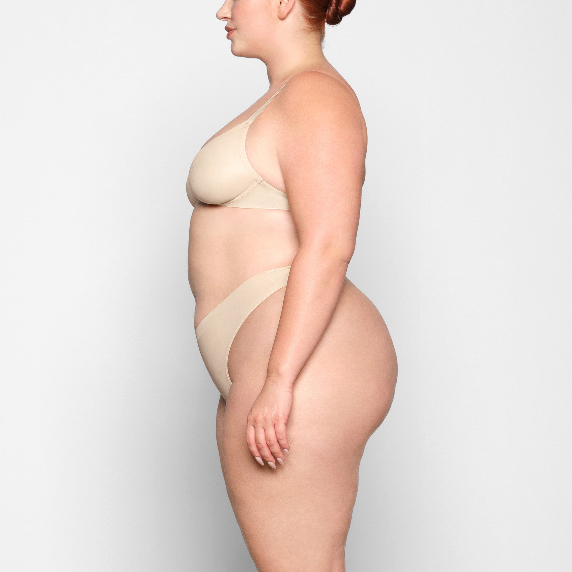 NO SHOW MOLDED UNLINED DEMI BRA WORN BY A MODEL IN SIDE VIEW