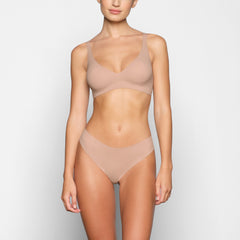 NAKED PLUNGE BRA WORN BY A MODEL IN FRONT VIEW 