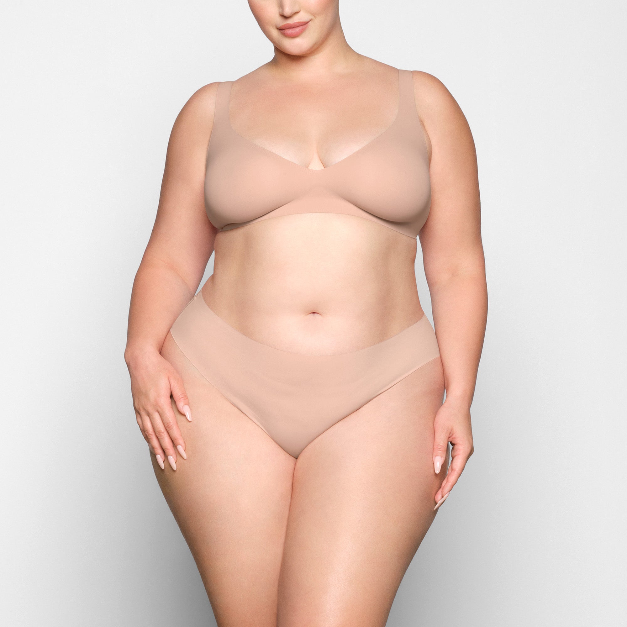 NAKED PLUNGE BRA WORN BY A MODEL IN FRONT VIEW 
