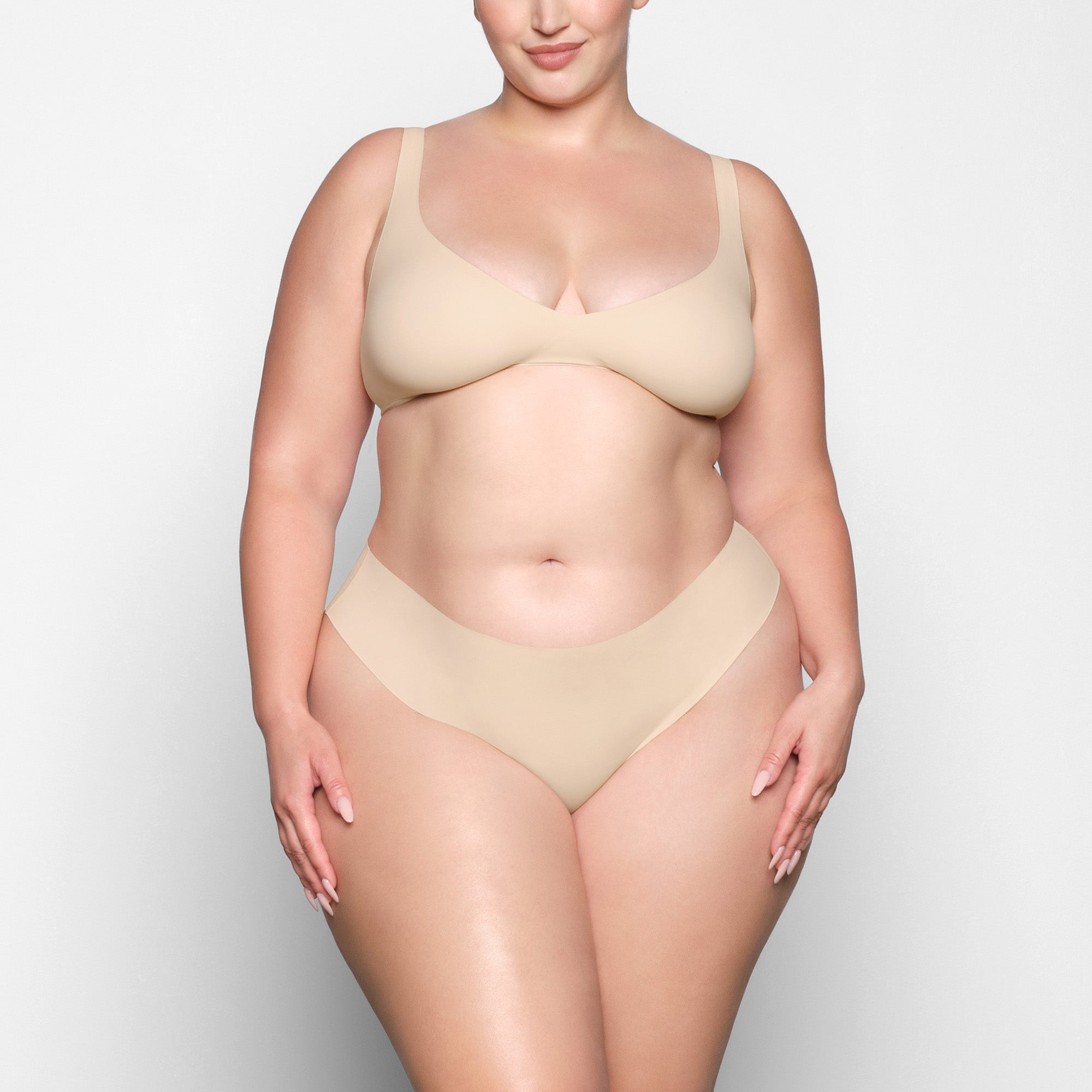NAKED PLUNGE BRA WORN BY A MODEL IN FRONT VIEW 