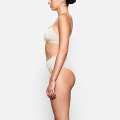 SIDE VIEW OF THE COTTON JERSEY FULL BRIEF ON A MODEL