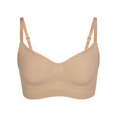 SEAMLESS SCULPT BRALETTE | CLAY (SHAPEWEAR BRALETTES, BRAS) LAYS FLAT ON A WHITE BACKGROUND | FLT