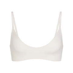 NikeSKIMS MATTE MICRO SCOOP BRA | IVORY LAYS FLAT ON A WHITE BACKGROUND | FLT