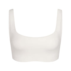 NikeSKIMS MATTE SCOOP NECK BRA | IVORY LAYS FLAT ON A WHITE BACKGROUND | FLT