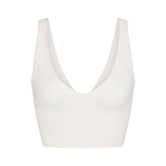 NikeSKIMS MATTE V-NECK BRA TOP | IVORY LAYS FLAT ON A WHITE BACKGROUND | FLT