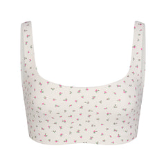 NikeSKIMS MATTE SCOOP NECK BRA | DITSY FLORAL PRINT LAYS FLAT ON A WHITE BACKGROUND | FLT