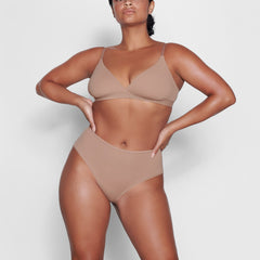 ON A MODEL FRONT VIEW FITS EVERYBODY CROSSOVER BRALETTE IN SIENNA