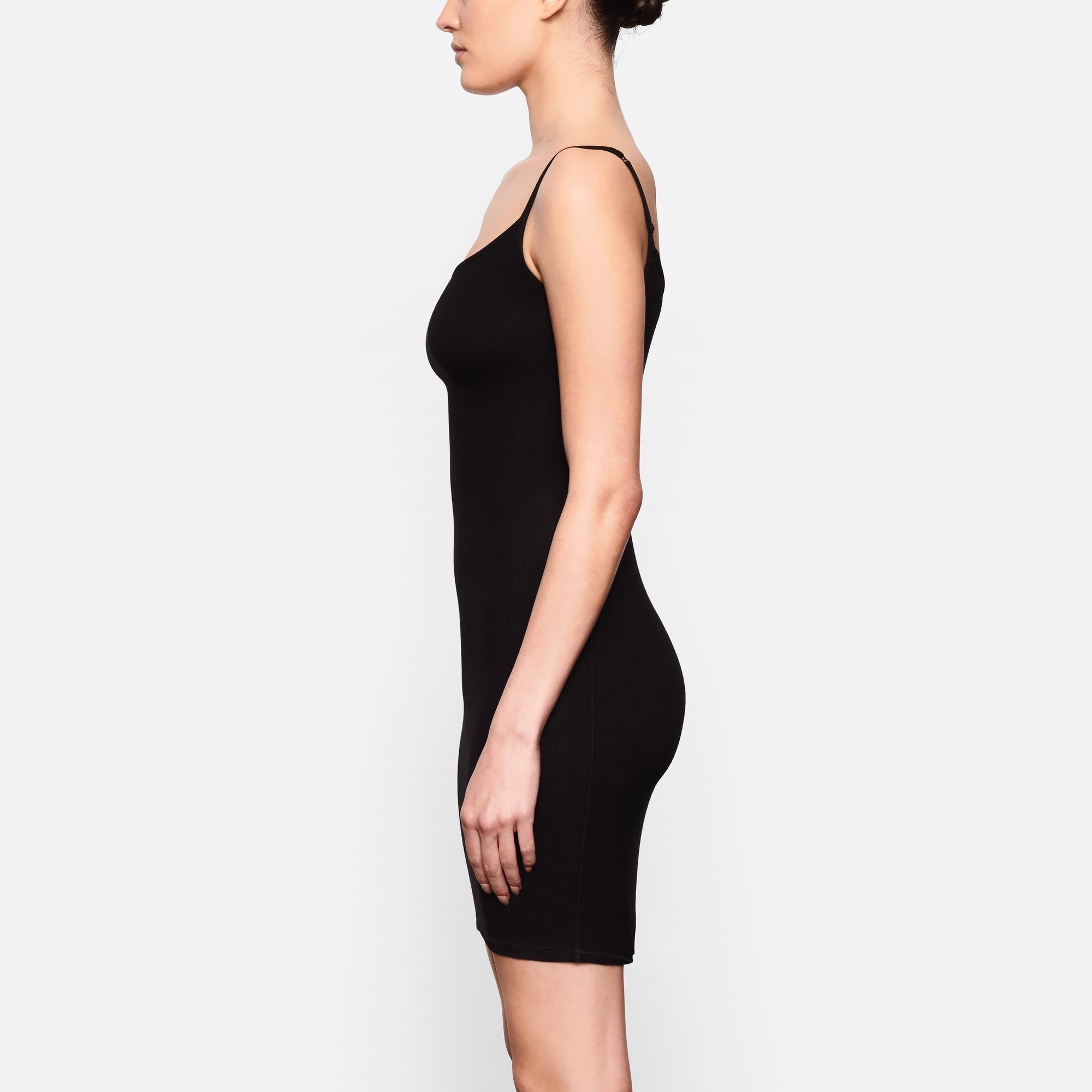 WORN BY A MODEL IN SIDE VIEW SOFT LOUNGE SLIP DRESS IN ONYX