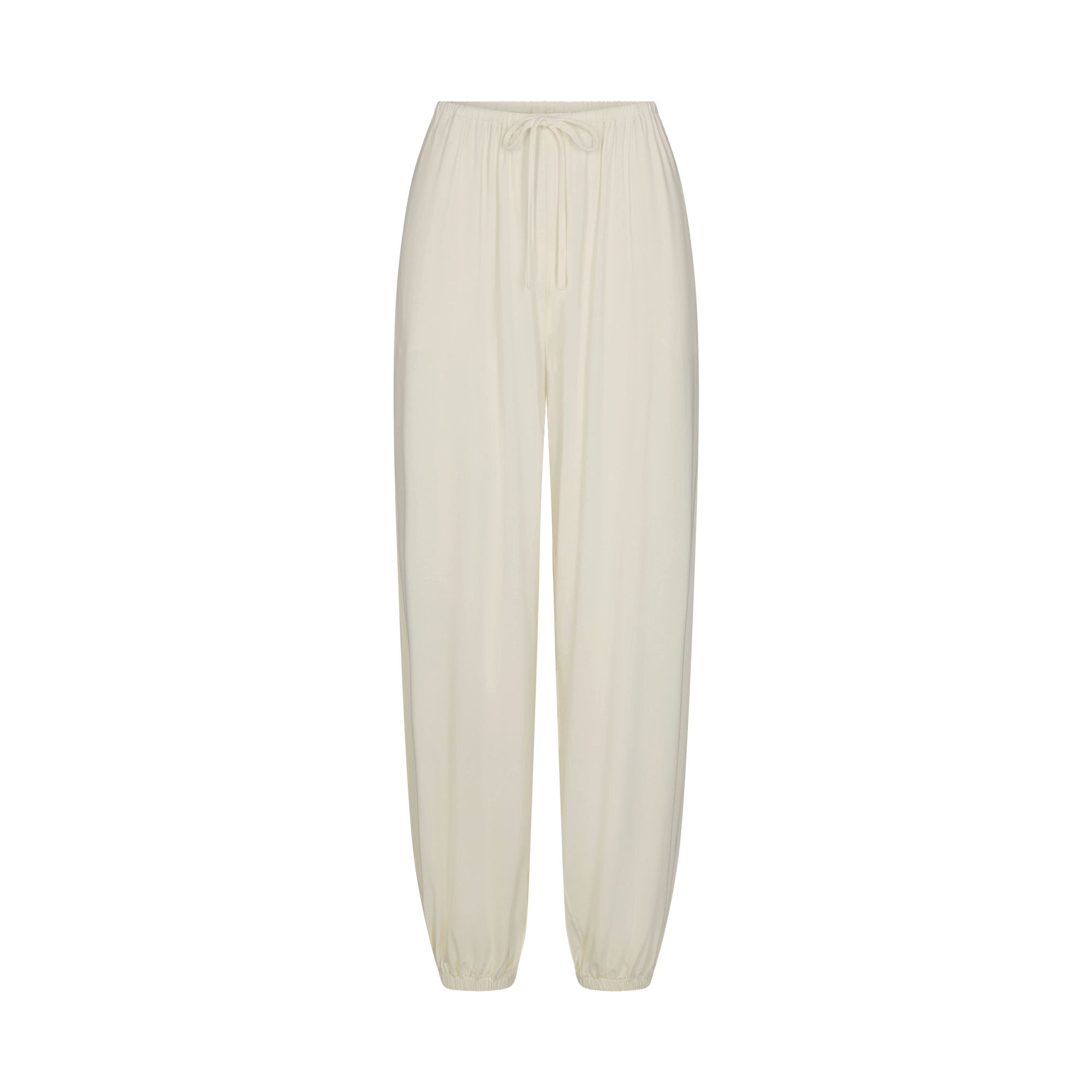 SKIMS SLEEP JOGGER | ECRU FLAT ON A WHITE BACKGROUND | FLT
