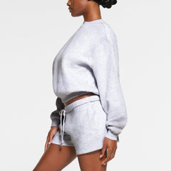 COTTON FLEECE CLASSIC CREWNECK WORN BY A MODEL IN SIDE VIEW