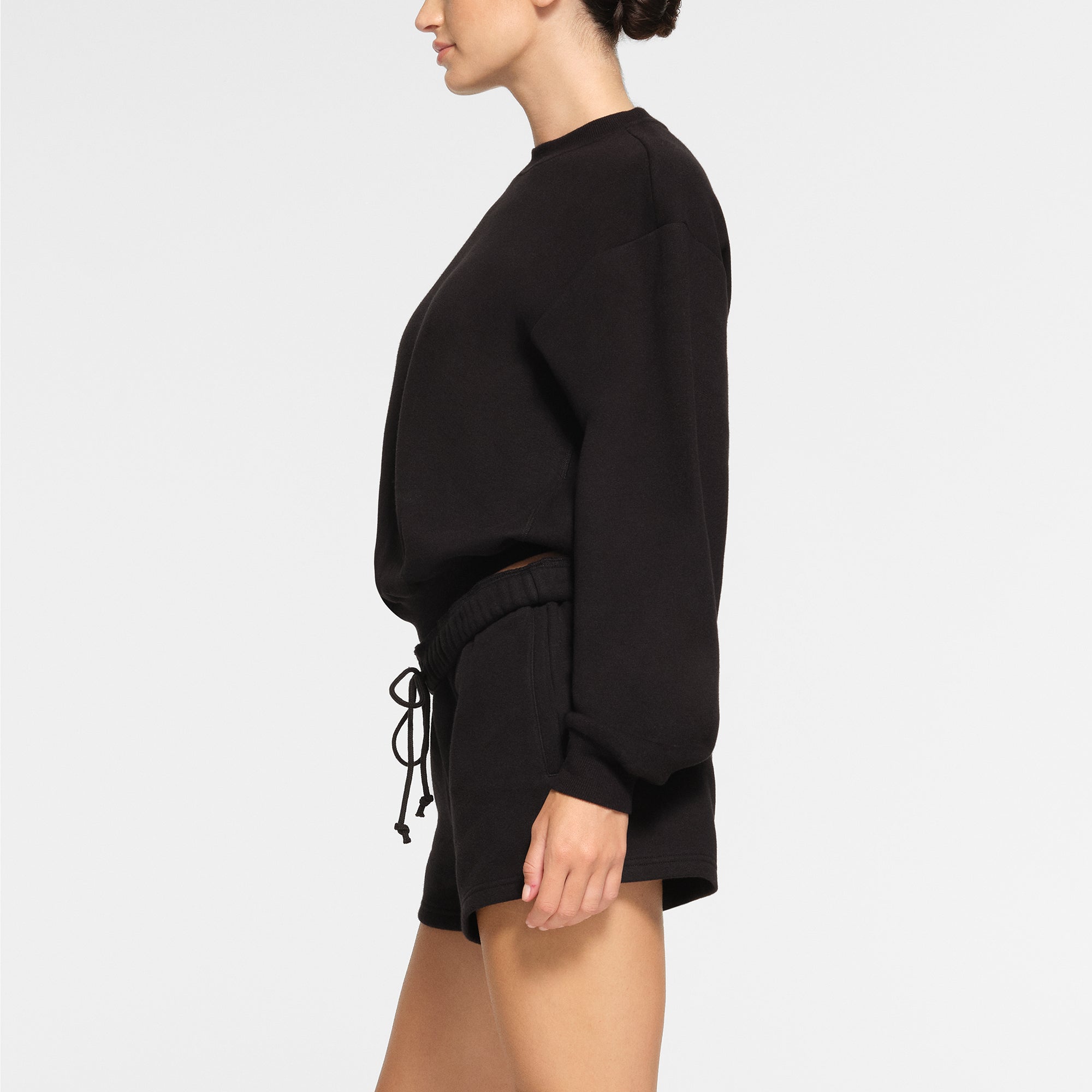 COTTON FLEECE CLASSIC CREWNECK WORN BY A MODEL IN SIDE VIEW