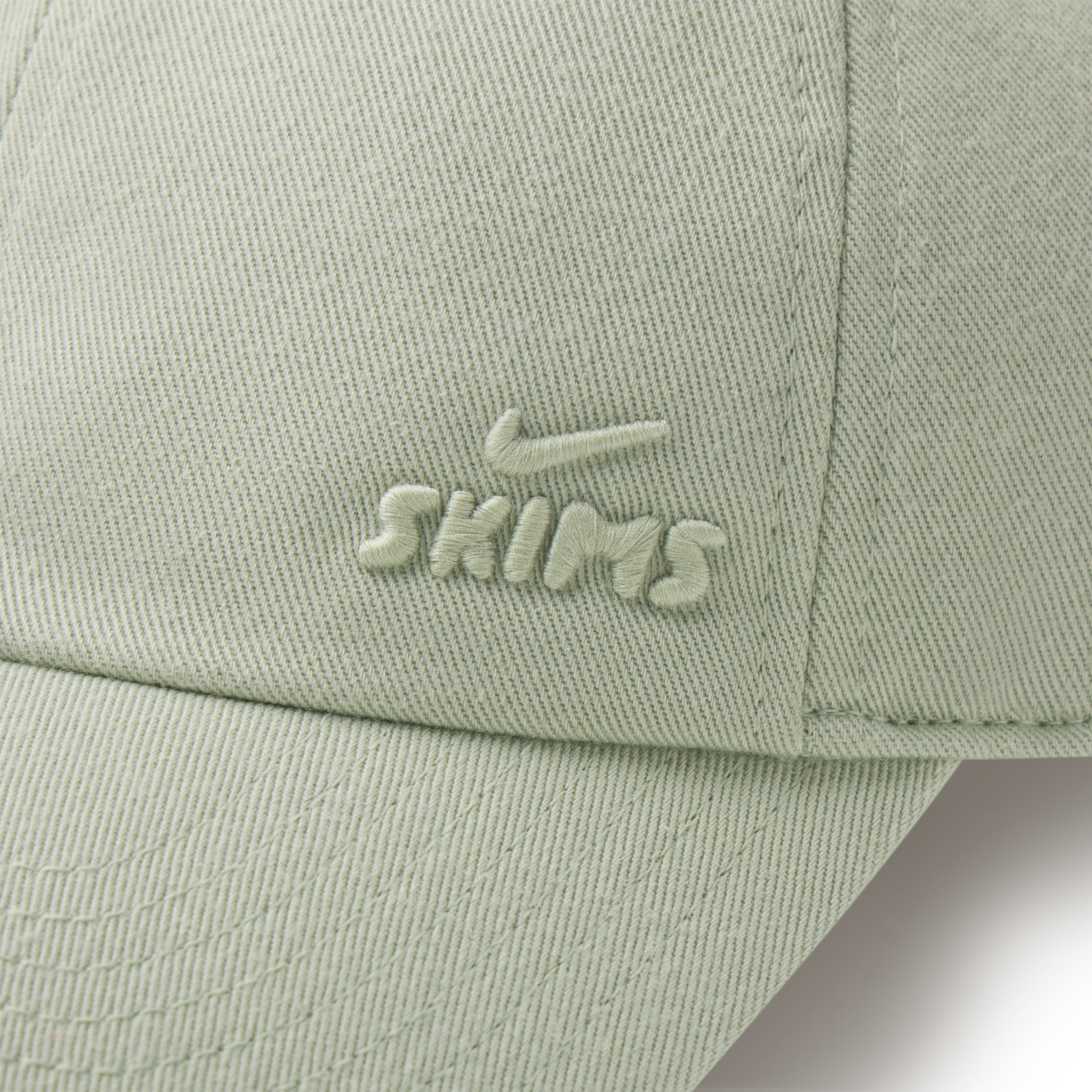 NikeSKIMS ACCESSORIES CLUB CAP | TALC ON A MODEL SIDE VIEW @ | FOCUS: 0.0, 1.0, 0.9