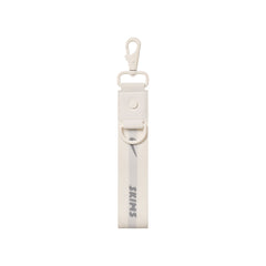 NikeSKIMS ACCESSORIES KEYCHAIN WRISTLET | IVORY LAYS FLAT ON A WHITE BACKGROUND