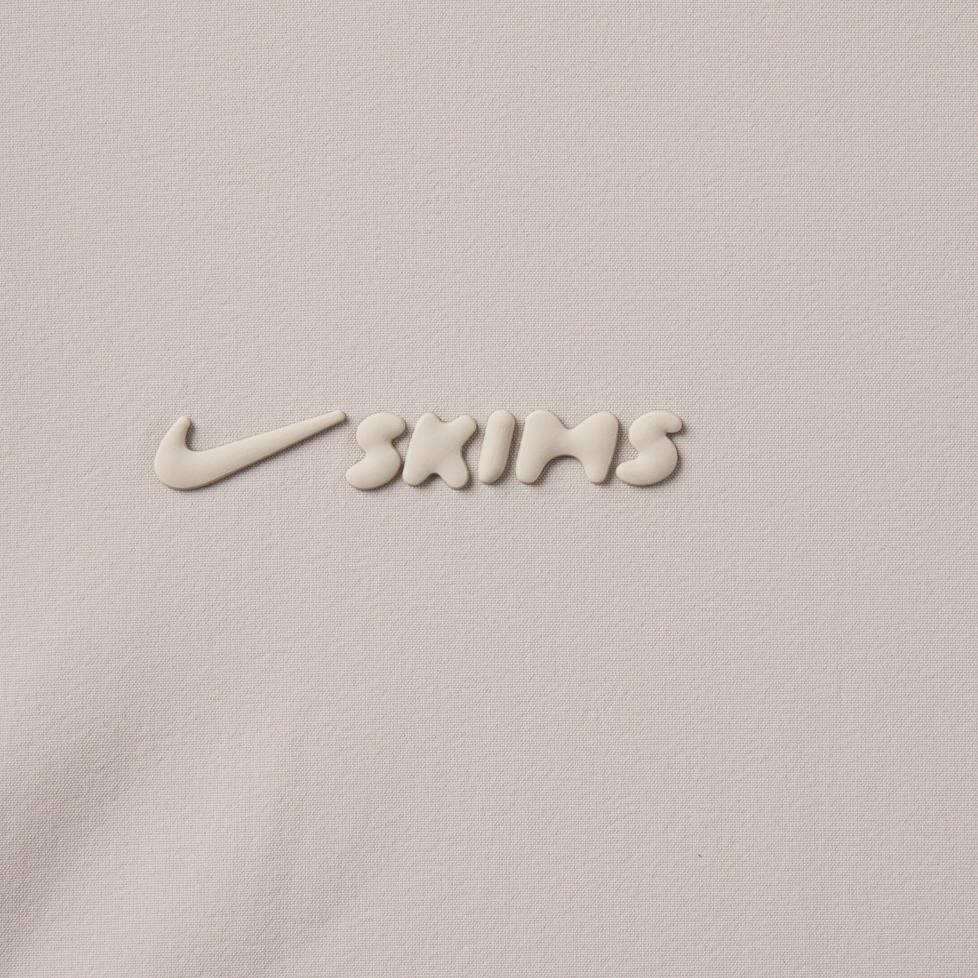 NikeSKIMS WOVEN NYLON OVERSIZED TRACK JACKET | STONE ADDITIONAL FABRIC DETAILS