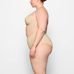 SMOOTHING HIGH WAIST BRIEF WORN BY A MODEL IN SIDE VIEW