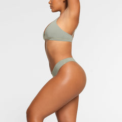 COTTON JERSEY DIPPED THONG WORN BY A MODEL IN SIDE VIEW