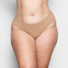 ON A MODEL FRONT VIEW FREE CUT MID WAIST THONG IN CLAY  | FOCUS: 0.1, 0.9, 0.9