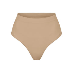 SEAMLESS SCULPT MID WAIST THONG | CLAY (SHAPEWEAR THONGS, PANTIES) LAYS FLAT ON A WHITE BACKGROUND | FLT