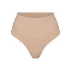 SEAMLESS SCULPT MID WAIST THONG | MICA (SHAPEWEAR THONGS, PANTIES) LAYS FLAT ON A WHITE BACKGROUND | FLT