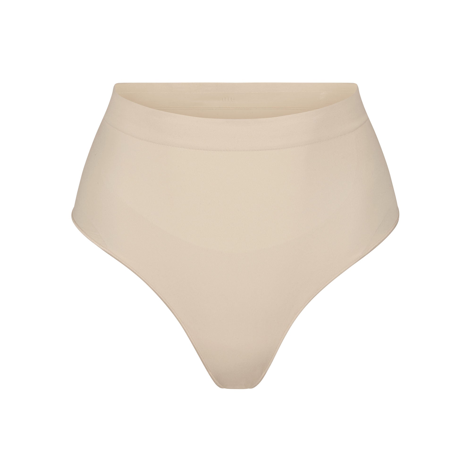 SEAMLESS SCULPT MID WAIST THONG | SAND (SHAPEWEAR THONGS, PANTIES) LAYS FLAT ON A WHITE BACKGROUND | FLT