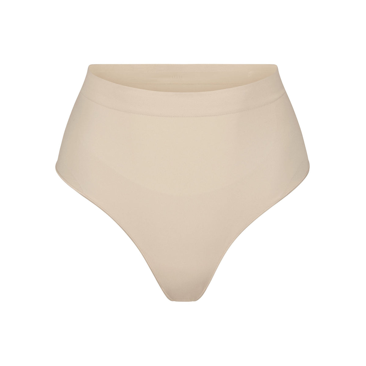 SEAMLESS SCULPT MID WAIST THONG | SAND (SHAPEWEAR THONGS, PANTIES) LAYS FLAT ON A WHITE BACKGROUND | FLT