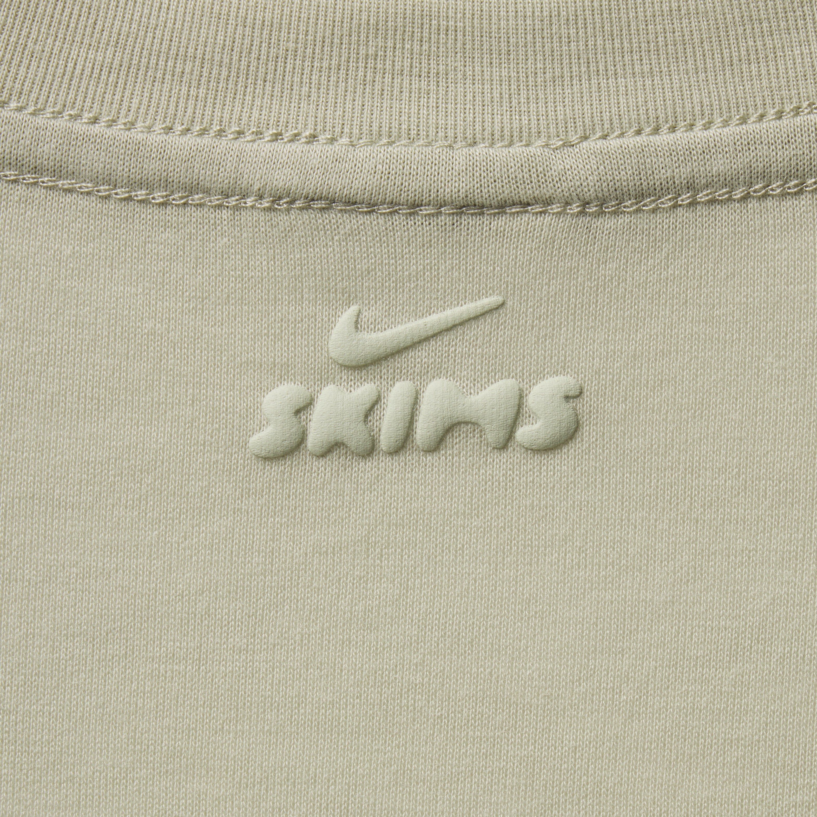 NikeSKIMS PERFORMANCE COTTON BLEND SHORT SLEEVE V-NECK TOP | TALC & LAYS FLAT ON A WHITE BACKGROUND | FLT
