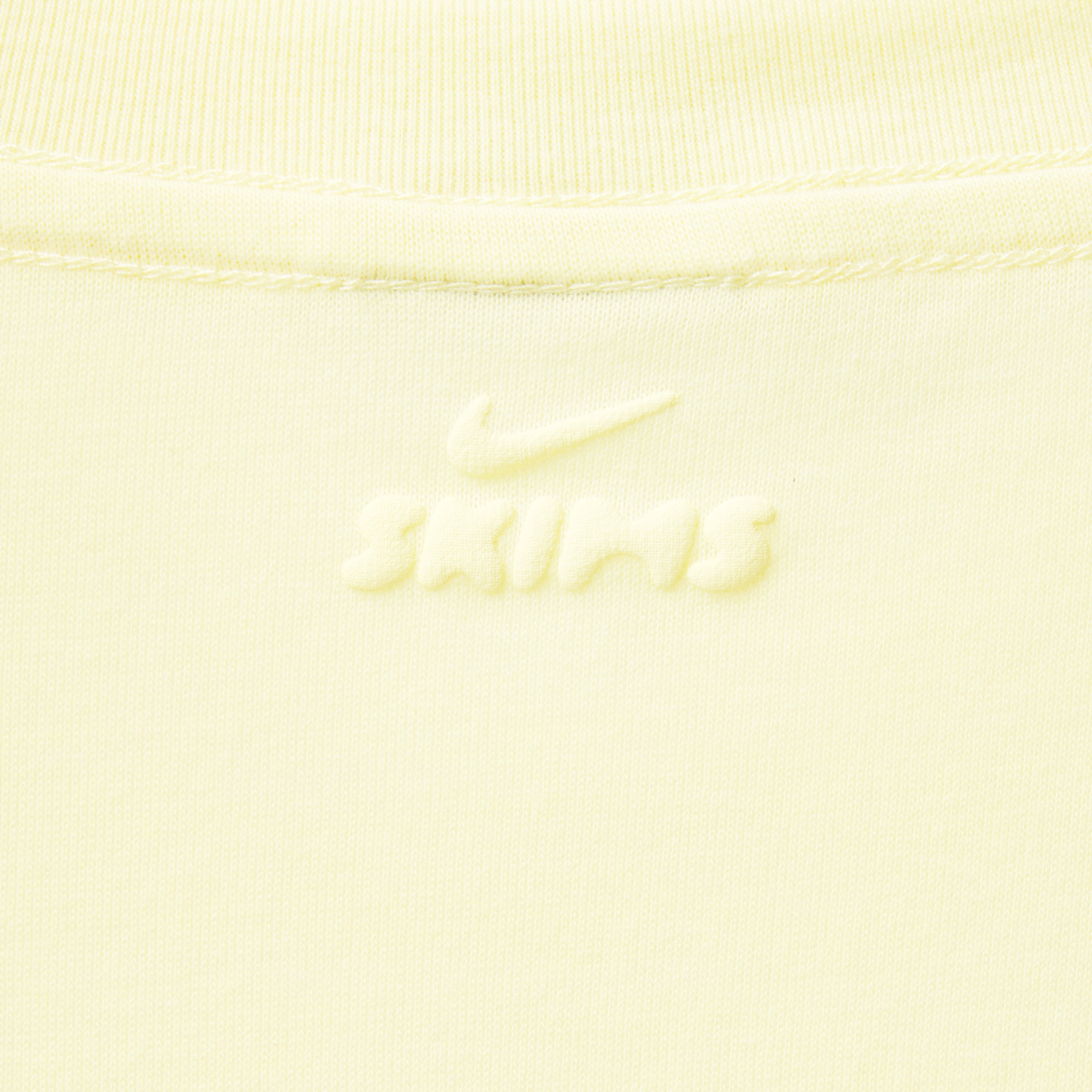 NikeSKIMS RIBBED SEAMLESS MUSCLE TANK | LEMON DROP & LAYS FLAT ON A WHITE BACKGROUND | FLT