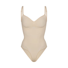 SEAMLESS SCULPT BRIEF BODYSUIT | SAND (SHAPEWEAR BODYSUITS) LAYS FLAT ON A WHITE BACKGROUND | FLT