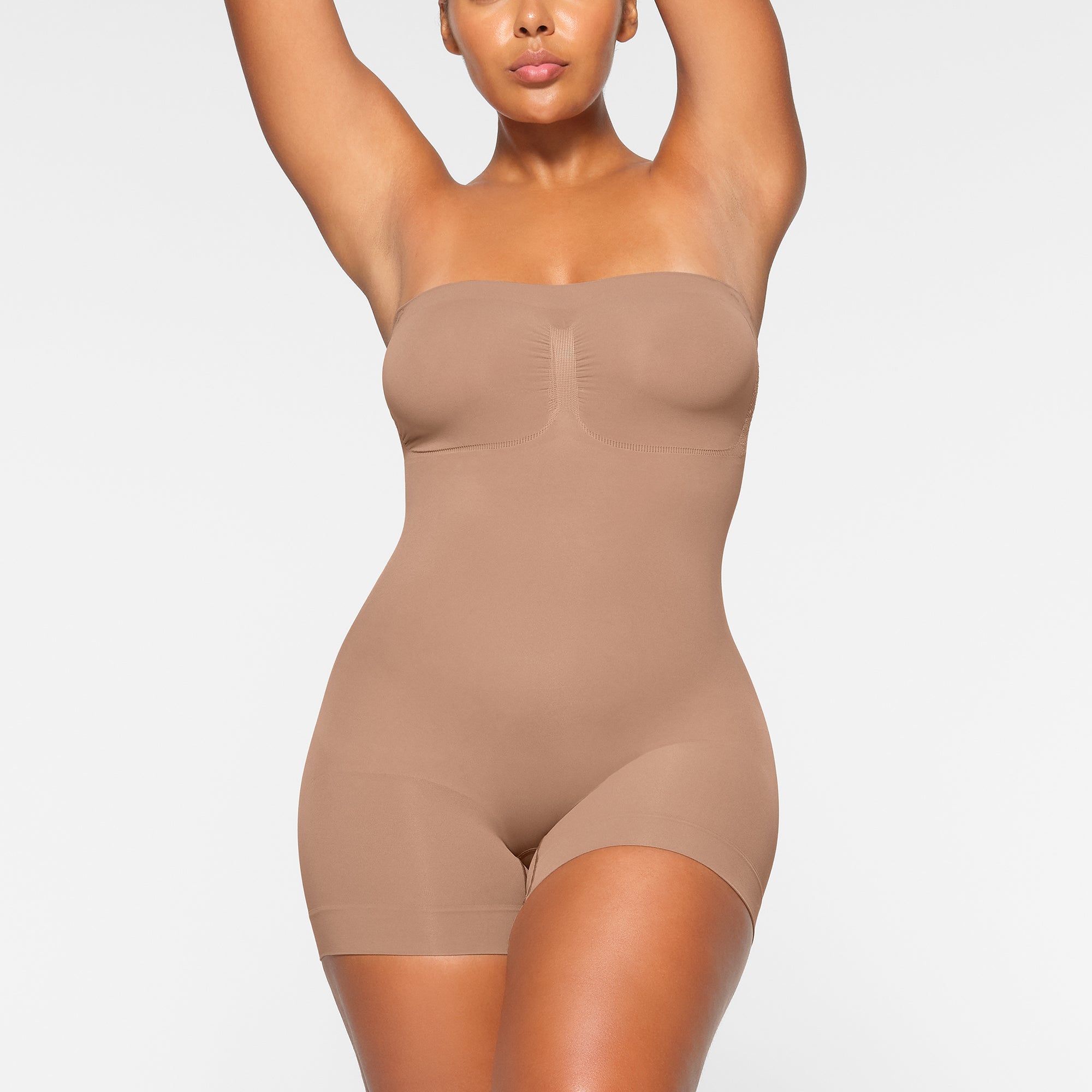 SEAMLESS SCULPT STRAPLESS MID THIGH BODYSUIT WORN BY A MODEL IN FRONT VIEW, XL