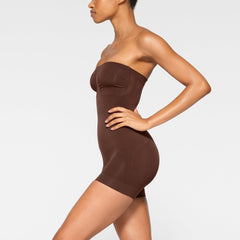 SEAMLESS SCULPT STRAPLESS MID THIGH BODYSUIT WORN BY A MODEL IN FRONT VIEW 