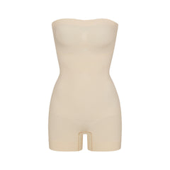 SEAMLESS SCULPT STRAPLESS SHORTIE BODYSUIT | SAND (ONESIES, BODYSUITS) LAYS FLAT ON A WHITE BACKGROUND | FLT