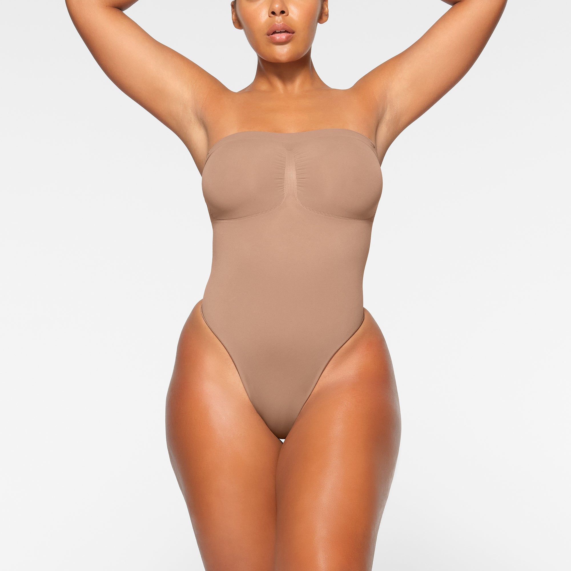 SEAMLESS SCULPT STRAPLESS THONG BODYSUIT WORN BY A MODEL IN FRONT VIEW, XL