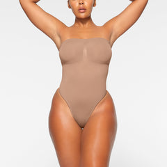 SEAMLESS SCULPT STRAPLESS THONG BODYSUIT WORN BY A MODEL IN FRONT VIEW, XL