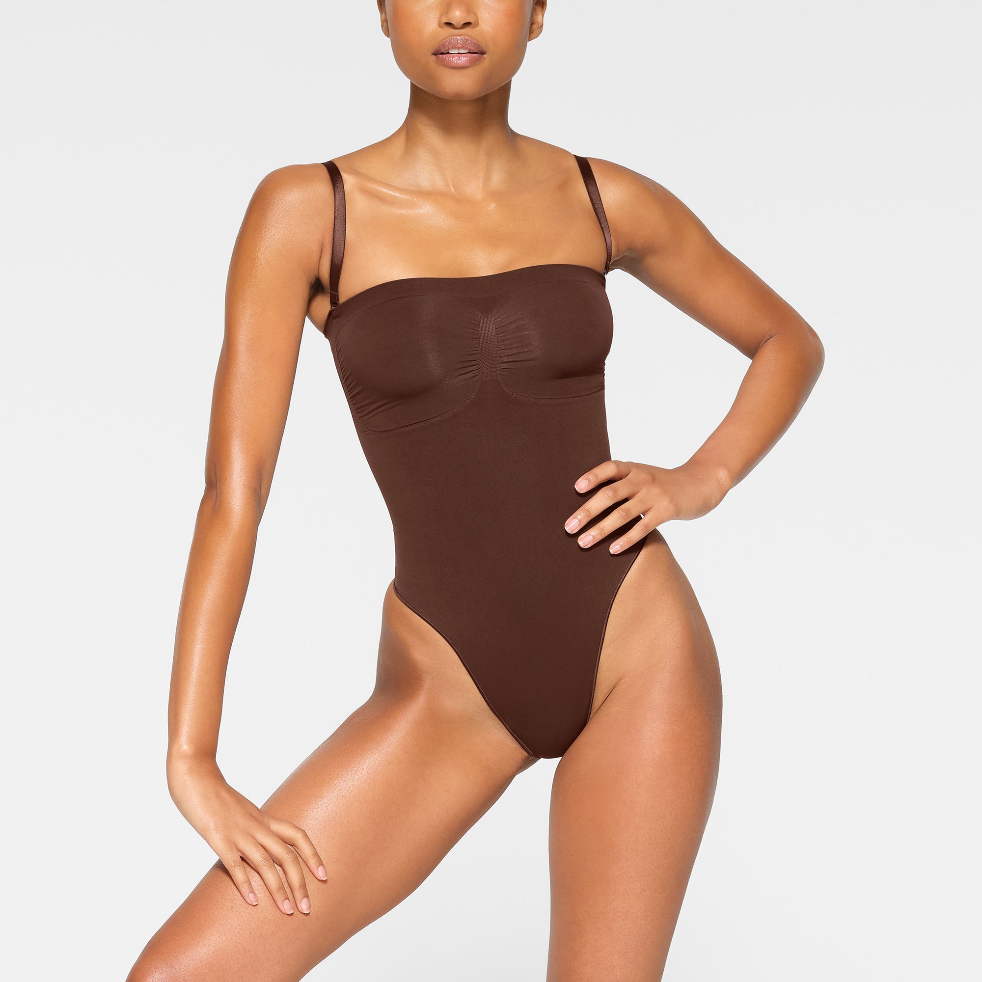 SEAMLESS SCULPT STRAPLESS THONG BODYSUIT WORN BY A MODEL IN FRONT VIEW