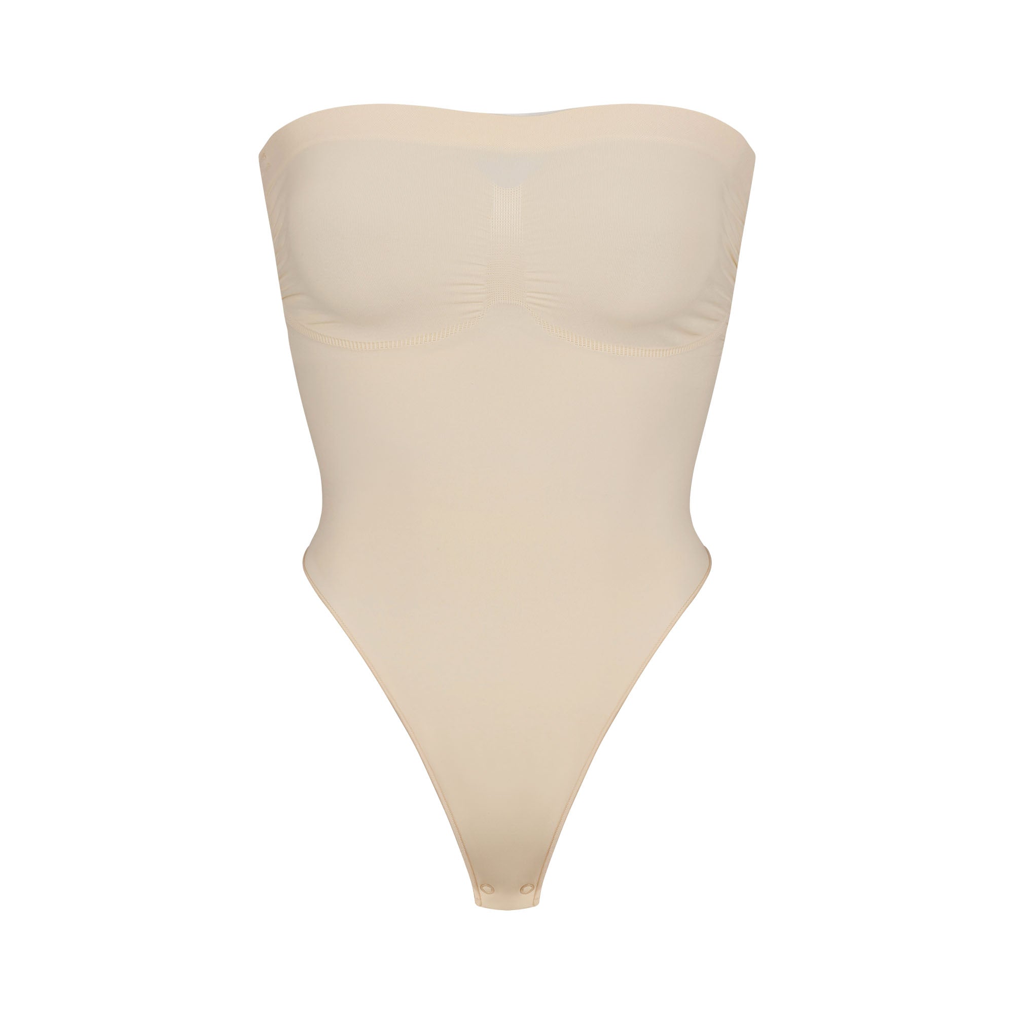 SEAMLESS SCULPT STRAPLESS THONG BODYSUIT | SAND (SHAPEWEAR BODYSUITS) LAYS FLAT ON A WHITE BACKGROUND | FLT