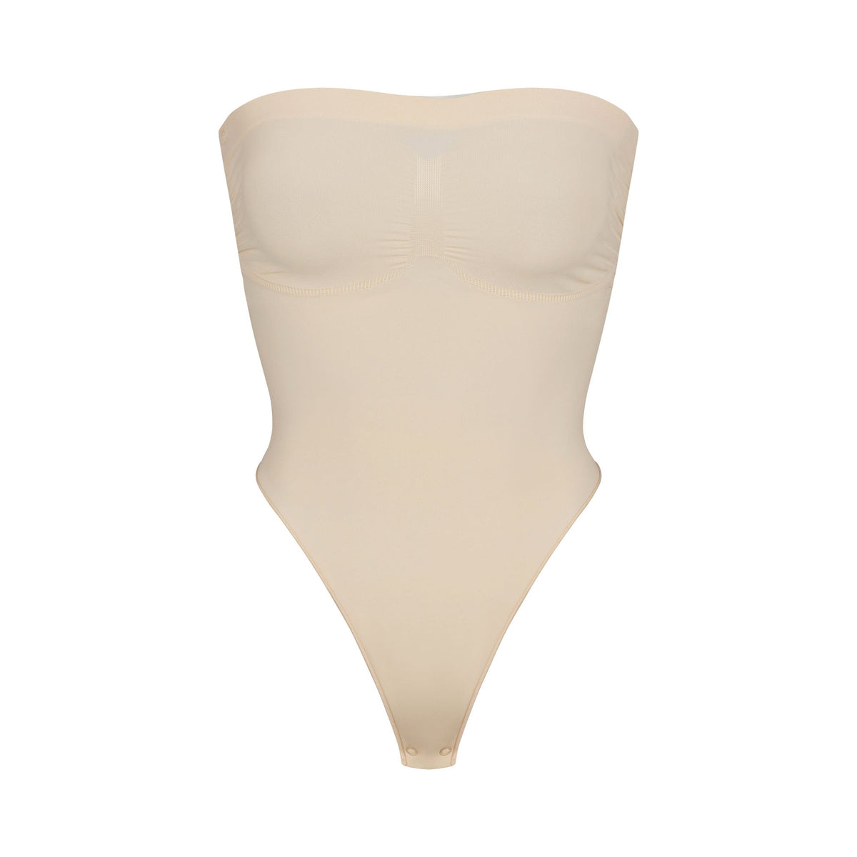 SEAMLESS SCULPT STRAPLESS THONG BODYSUIT | SAND (SHAPEWEAR BODYSUITS) LAYS FLAT ON A WHITE BACKGROUND | FLT