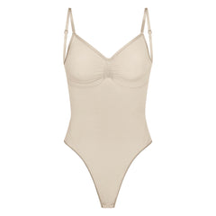 SEAMLESS SCULPT LOW BACK THONG BODYSUIT | SAND (LOW BACK SHAPEWEAR, BODYSUITS) LAYS FLAT ON A WHITE BACKGROUND | FLT