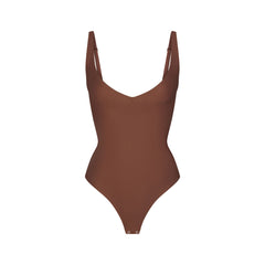 SKIMS BODY CORE SCULPT PLUNGE THONG BODYSUIT | JASPER (SHAPEWEAR BODYSUITS) FLAT ON A WHITE BACKGROUND | FLT