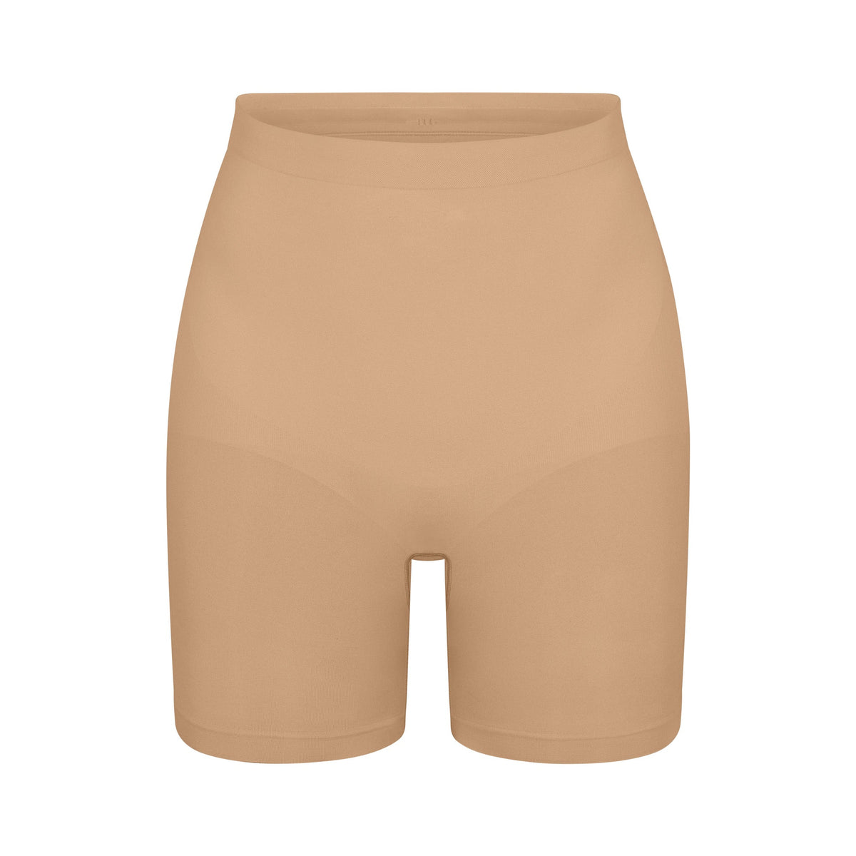 SEAMLESS SCULPT MID THIGH SHORT | CLAY (SHAPEWEAR SHORTS, SHAPEWEAR) LAYS FLAT ON A WHITE BACKGROUND | FLT