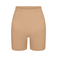 SEAMLESS SCULPT MID THIGH SHORT | CLAY (SHAPEWEAR SHORTS, SHAPEWEAR) LAYS FLAT ON A WHITE BACKGROUND | FLT