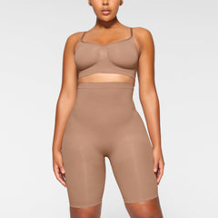 SEAMLESS SCULPT HIGH-WAISTED ABOVE THE KNEE SHORT WORN BY A MODEL IN FRONT VIEW, XL