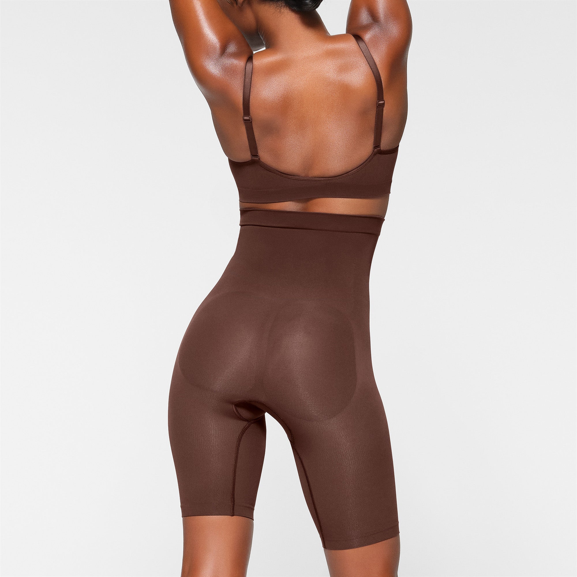 SEAMLESS SCULPT HIGH-WAISTED ABOVE THE KNEE SHORT ON A MODEL BACK VIEW